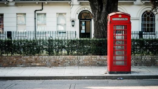 Red telephone booth on a street in England Red telephone booth on a street in England