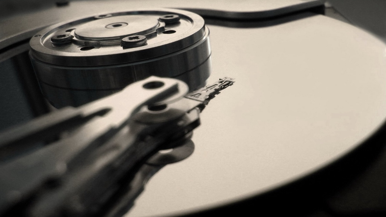 Person standing in front of a giant computer screen with numbers, data